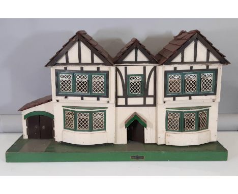 Vintage wooden dolls house by Amersham Toys with front bay windows, opening lattice style windows, tiled roof, 2 hinged front