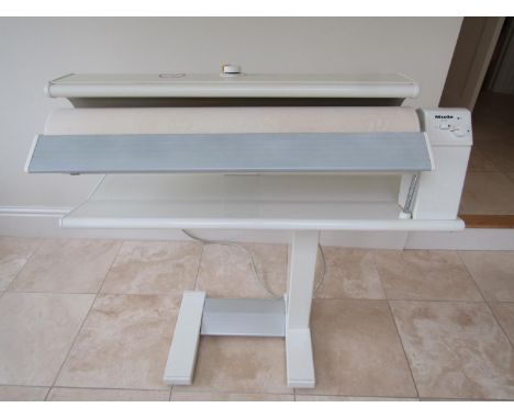A Miele rotary iron model B890, together with an office chair, the cylinder 84cm long, 1m wide overall 
