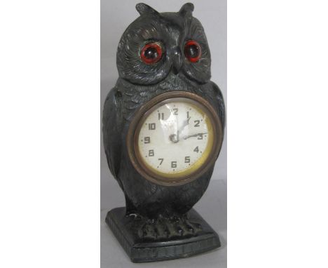A spelter bedside or mantle clock in the form of an owl, with eight day time piece 