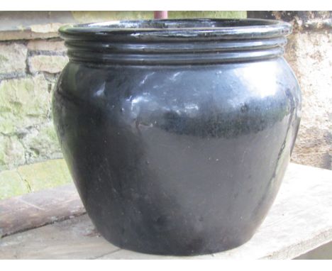 A glazed oviform garden planter approximately 50cm diameter x 43 cm high 