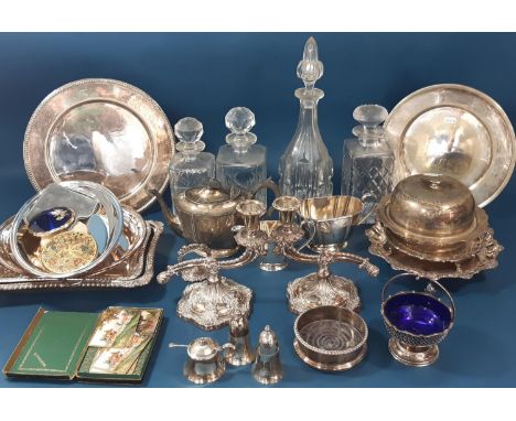 A mixed selection of silver plated table ware, including a pair of candlesticks,tureens, a three piece tea service, loose fla