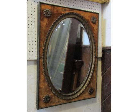 A vintage wall mirror with oval bevelled edge plate, within a gilt and outer rectangular material covered frame, with applied