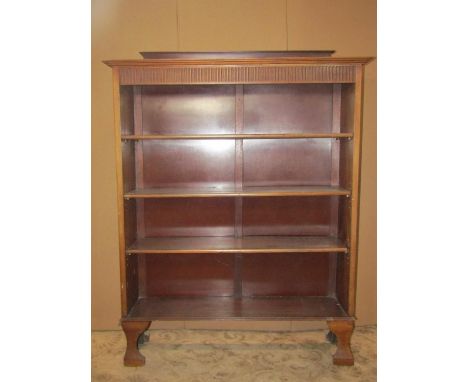An Edwardian walnut slender freestanding open bookcase with fluted frieze over three adjustable shelves and bracket feet, 107
