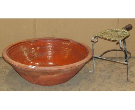 A terracotta pan of circular tapered form with glazed interior, 53cm diameter x 16cm high, together with a 19th century brass