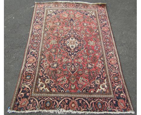 A Tabriz type carpet with an all over floral pattern on a pink and blue ground, 186cm x 125cm approx 