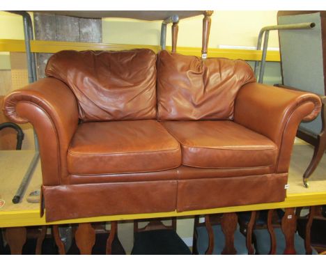 A Laura Ashley two seat sofa, 'The Chichester' upholstered in a mid-brown leather, 150cm wide 