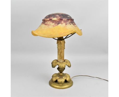 An early 20th century Daum glass mushroom lamp, the mottled red and yellow domed shade with lobbed sides, with etched signatu