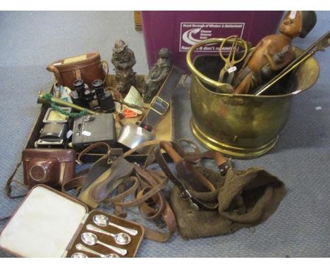 A pair of International military binoculars, vintage camera, a cow bell, a boy scout belt, horse leathers and other itemsLoca