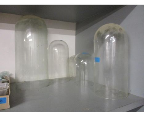 Five vintage glass clock domes, 18cm high - 43cm high, minor chips to rim and one plastic exampleLocation: G 