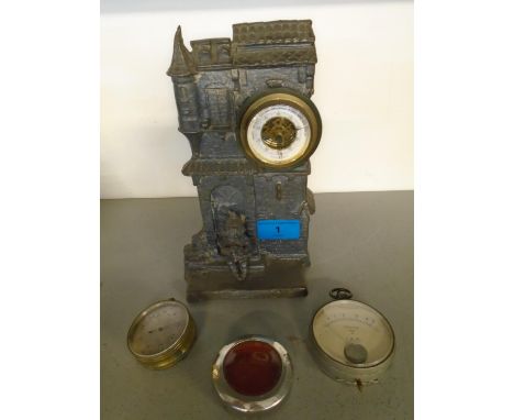 An early 20th century barometer in a cast metal stand depicting a pixie seated in front of a house, a barometer with silver d