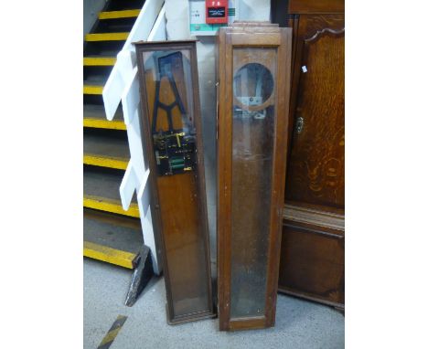 An oak and a walnut master Synchronome clock cases each with a movement 126cm h and 130cm hLocation: G 