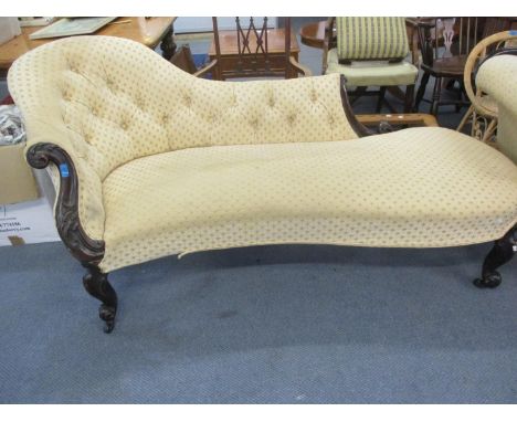 A Victorian rosewood framed chaise longue with scroll and floral carved ornament and part button upholstered, on cabriole, sc