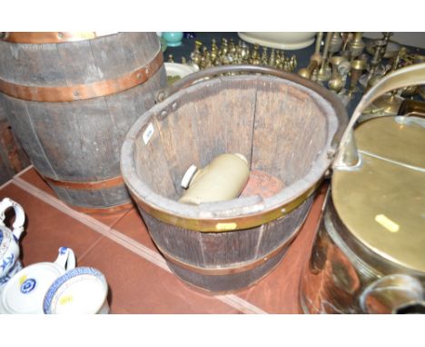 An oak coopered pail together with ceramic hot water bottle