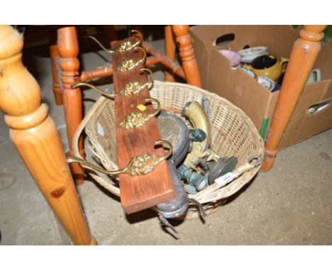 A wicker basket and contents of lion mask coat hooks, pair brass bellows, pair of cherub decorated candlesticks, silver plate