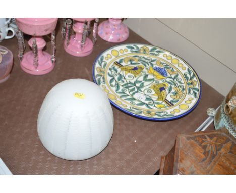 A Spanish charger decorated with birds amongst foliage together with a glass light shade