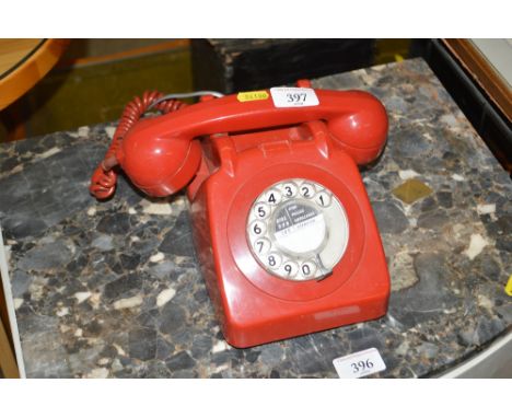 A vintage GPO red rotary dial telephone
