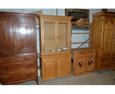 A Marks &amp; Spencer light oak display cabinet fitted three drawers raised on cupboard base