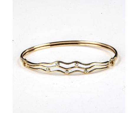 A modern 9ct gold diamond openwork torque bangle, set with modern round brilliant-cut diamonds, internal dimensions 6.5cm x 5