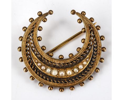 A Victorian Etruscan Revival 15ct gold and graduated pearl crescent moon brooch, beaded border with openwork wire twist decor