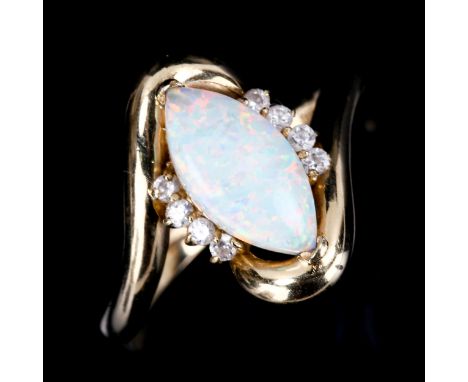 A modern 14ct gold synthetic opal and cubic zirconia crossover ring, set with marquise cabochon synthetic white opal, setting