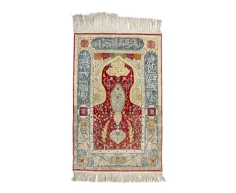 A fine silk prayer rug Iran, 20th Centuryof rectangular form, woven in polychrome silks with a central mihrab filled with flo