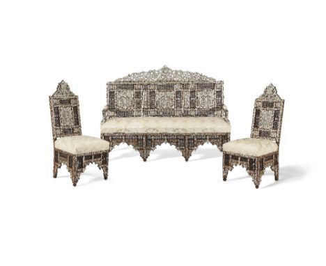 A Damascus mother-of-pearl-inlaid wood sofa and two chairs Syria, circa 1900each of typical form, the feet interspersed by ar