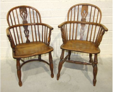 A 19th century yew wood and elm comb-back Windsor chair with crinoline stretcher and another elm Windsor chair, (2). 