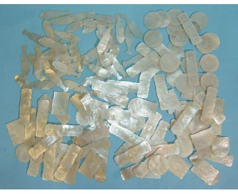 A collection of approximately 140 mother-of-pearl games counters of various shapes, including 44 fish shape counters, in lacq