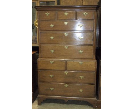 An 18th century oak chest-on-chest, the upper part with moulded cornice, above three small and three large drawers within flu