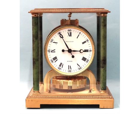 A Jaeger LeCoultre Vendôme Atmos clock, with white enamel dial and Roman numerals, within the gilt metal gadrooned case and g