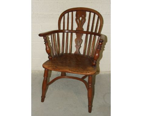 A 19th century yew wood comb-back Windsor chair with shaped elm seat. 