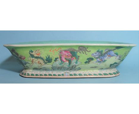 A Chinese famille rose rectangular footed bowl decorated with mythical beasts in a rocky landscape, Jiajing seal mark to base