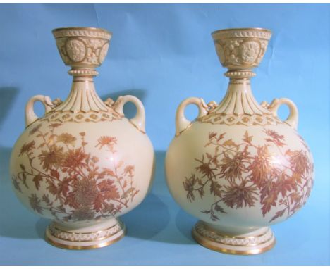 A pair of Royal Worcester baluster-shaped two-handled vases, having a cup neck with gilt floral decoration, puce factory mark