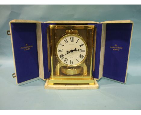 A Jaeger LeCoultre Atmos clock, the plain white enamel dial in plain gilt metal case with transparent sides and top panel, 22