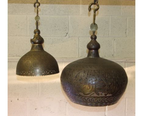 A large Egyptian pierced metal hanging light bowl with extension hook, 70cm high approximately, 46cm diameter and a smaller h