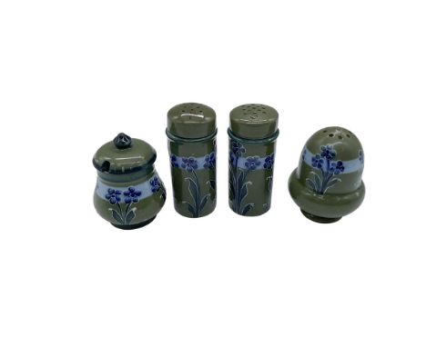 A collection of English pottery; blue and green glaze and adorned with blue five-petal flowers in tubeline outlines. Includes