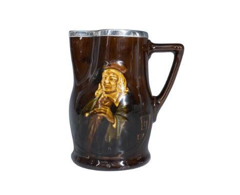 This pitcher, finished in Kingsware rich brown lustrous glaze, features Hogarth in high relief and is topped with a hallmarke