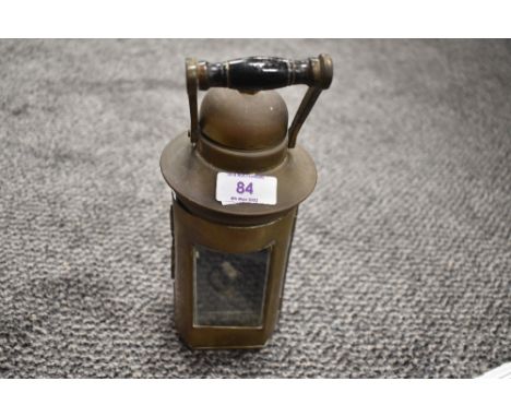 A 1943 dated brass oil lamp with glass door to front and handle, impressed with L.S.CO to lower front.