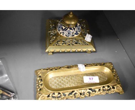 A decorative brass Victorian ink well with blue and white ceramic liner and a similar desk tidy.