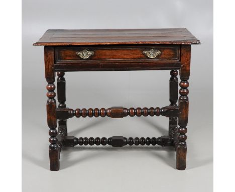 A CHARLES II OAK SIDE TABLE. the moulded edge top over single drawer with applied moulding, on turned and block legs, united 