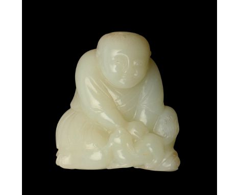 CHINESE CELADON JADE FIGURE. Probably 19thc, a carved celadon jade of a crouching figure, the figure with a cat by his claspe