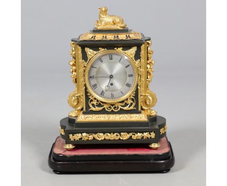 A 19TH CENTURY FRENCH ORMOLU MANTEL CLOCK. the silvered dial with Roman numerals and heart pierced hands, the case surmounted