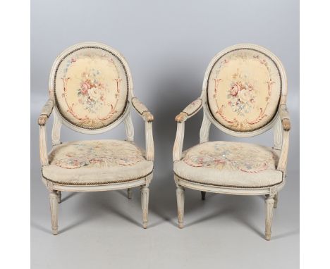 A PAIR OF FRENCH PAINTED BEECH OPEN ARMCHAIRS. early 20th century, with brass studded floral tapestry style upholstery, heigh