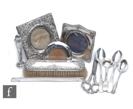 A parcel lot of assorted hallmarked silver items to include three photograph frames, flat ware, a desk seat etc, various date