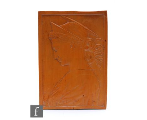 An early 20th Century cedar wood portrait plaque or panel of rectangular form, carved in shallow relief depicting a female fi