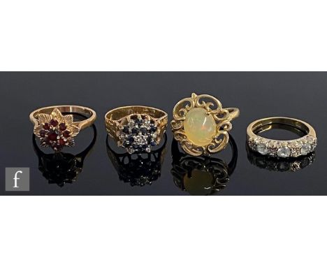 Four 9ct hallmarked stone set rings to include sapphire and diamond, garnet and water opal examples, total weight 14.4g, vari