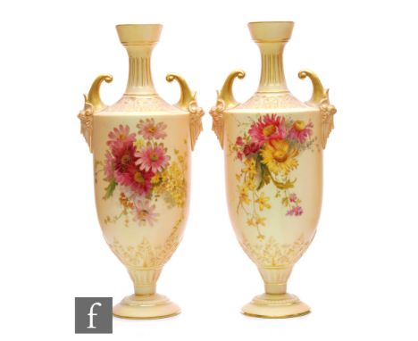 A pair of Royal Worcester blush ivory shape 1759 pedestal vases decorated with flowers with mask head handles, puce mark with