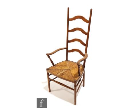 An Arts and Crafts oak ladder back armchair, designed by William Birch for Liberty &amp; Co, with ring turned capitals over a