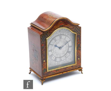 A 1930s chinoiserie mahogany cased mantle clock, engraved silvered arch dial enclosed by a glazed door, the case decorated wi