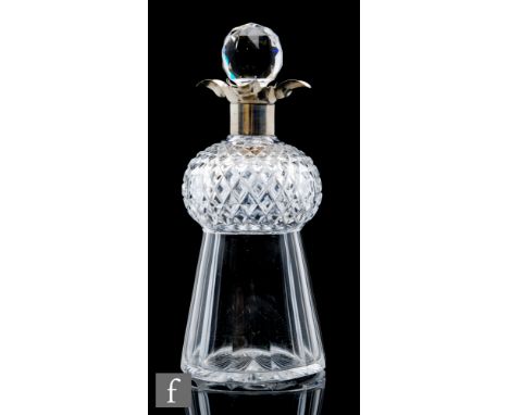 A late 19th Century clear crystal glass decanter of thistle form with slice and mitre cut body below an applied silver collar